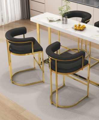 Mida Bar Chair featuring a curved black faux leather C-shaped backrest and a high-shine gold-finished stainless steel sled base at a white marble kitchen island